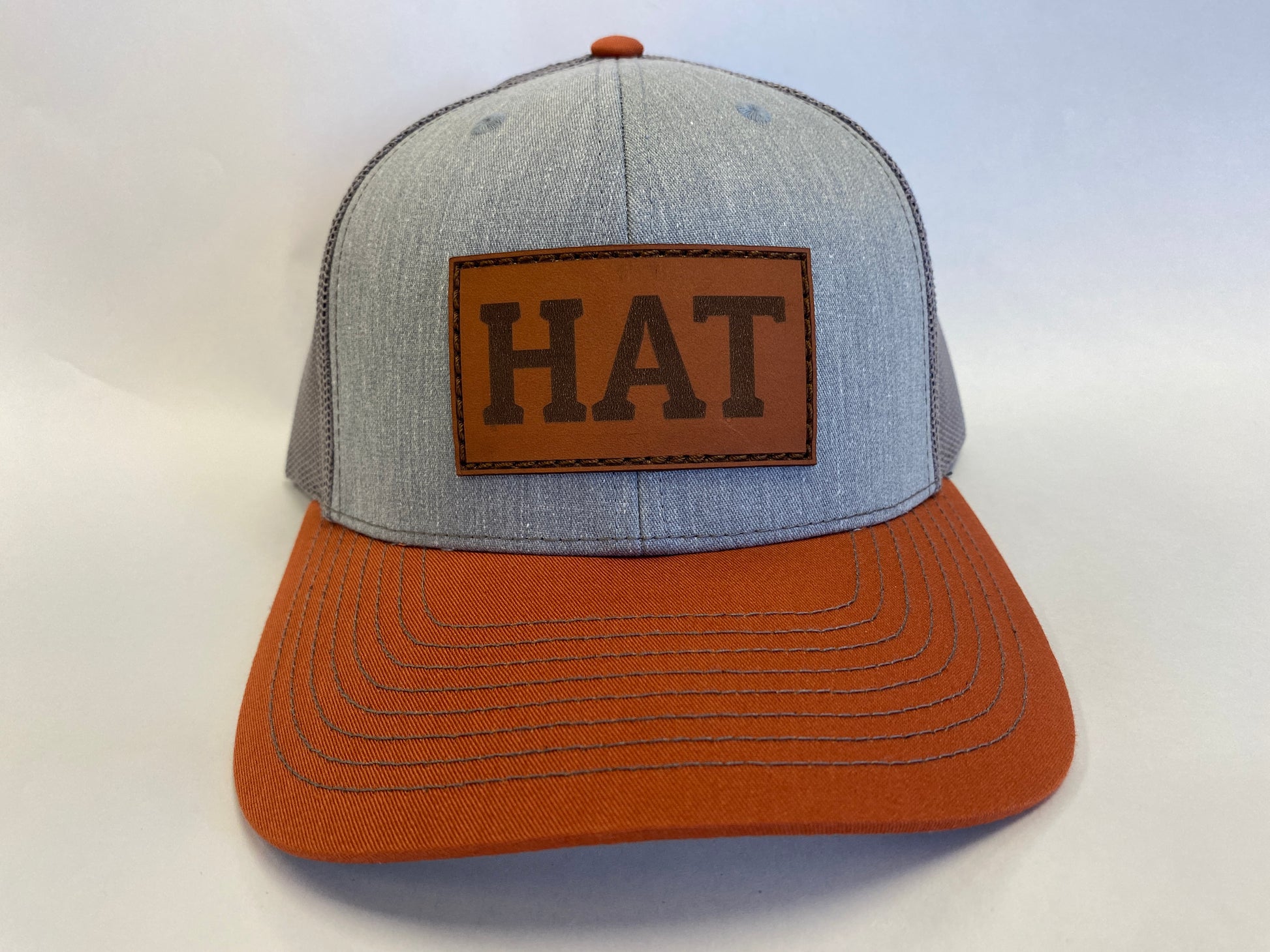 Leather Patch Trucker Hat light gray and dark orange