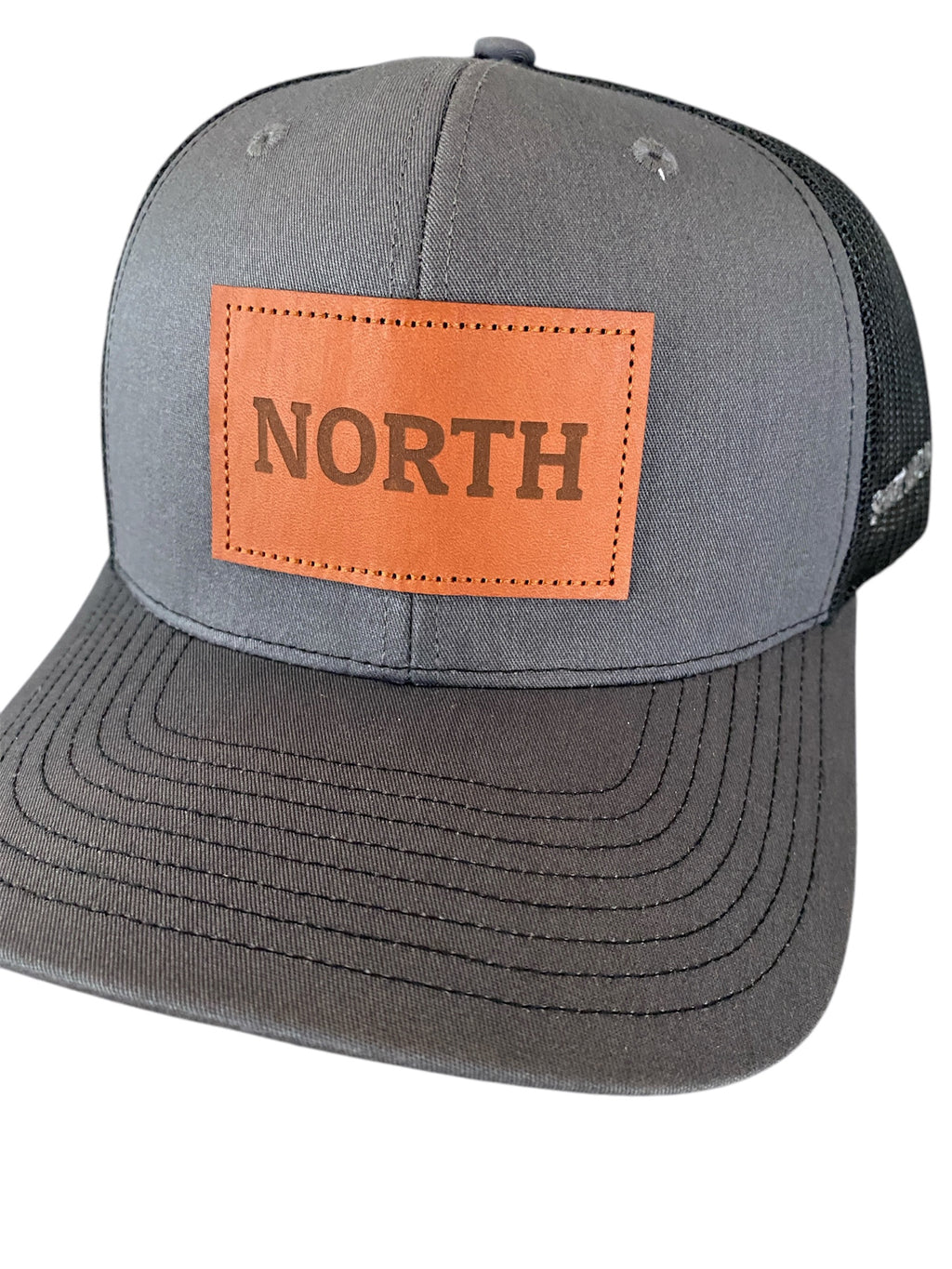 Leather Patch NORTH Trucker Hat in charcoal/black
