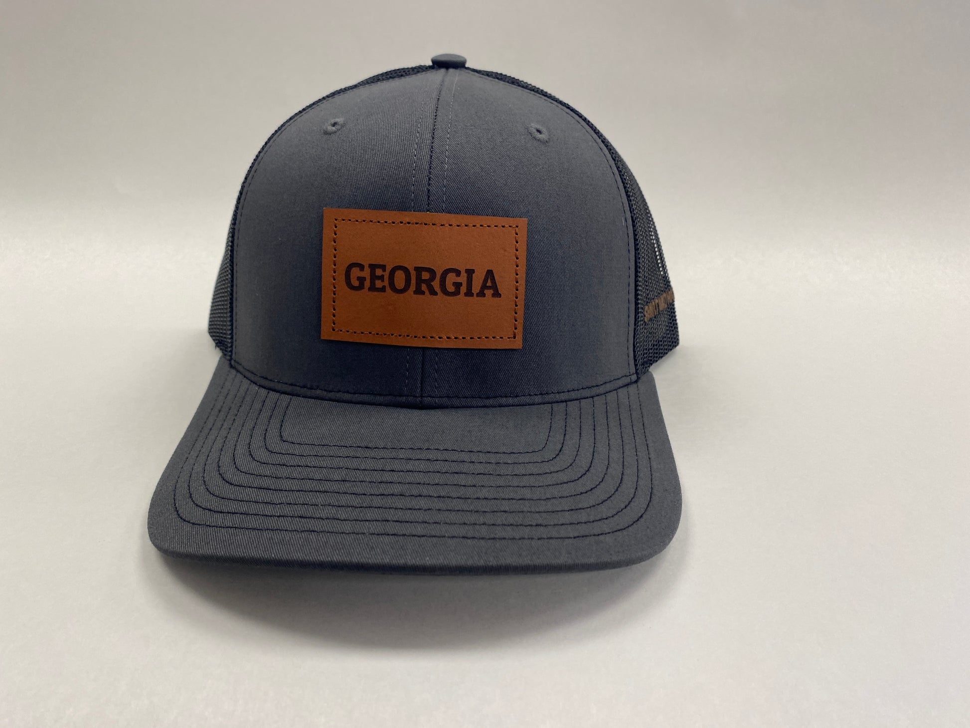Leather Patch GEORGIA Trucker Hat in charcoal/black